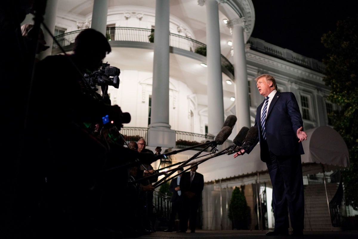 President Trump talks to members of the press on the South Lawn of the White House, August 23, 2019.