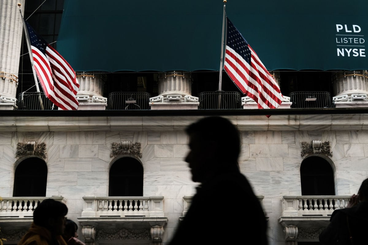 People walk by the New York Stock Exchange on November 4, 2019, in New York City.