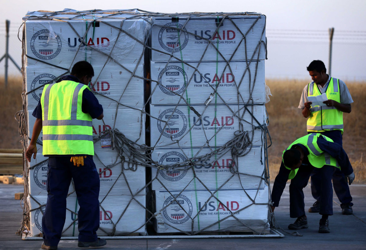 Airport personnel check humanitarian aid supplies from USAID in Arbil, the capital of the autonomous Kurdish region of northern Iraq, on September 2, 2014.