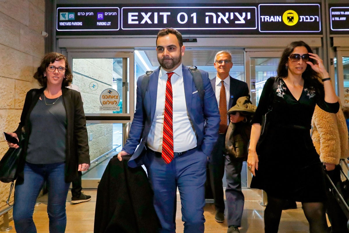 Omar Shakir walks through an airport
