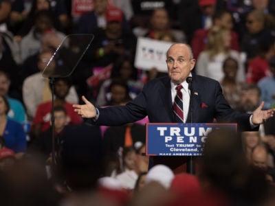 Rudy Giuliani speaks at a podium during a Trump rally