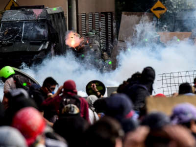 Demonstrators clash with riot police during a protest against the government in Santiago, Chile, on November 18, 2019.