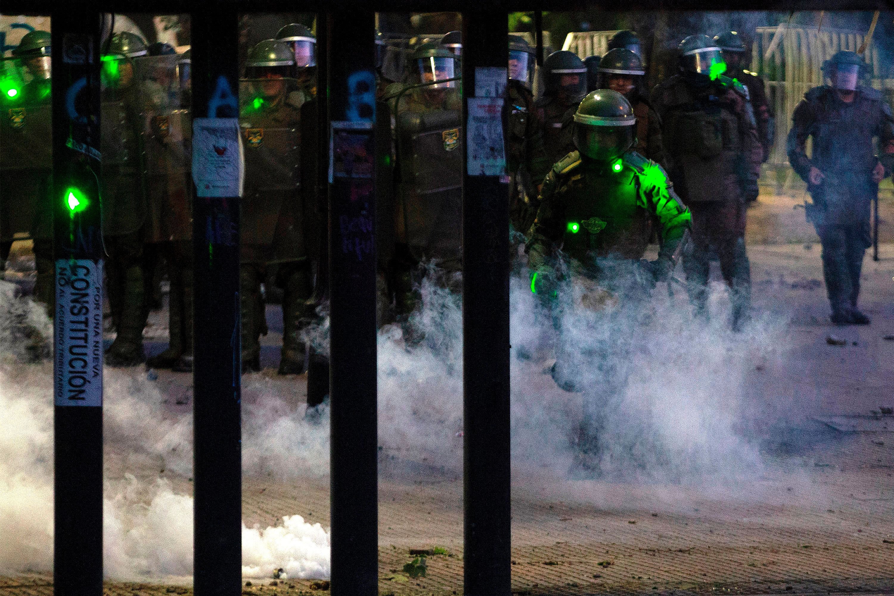 Riot police approach during a protest in Santiago, Chile, on November 22, 2019.