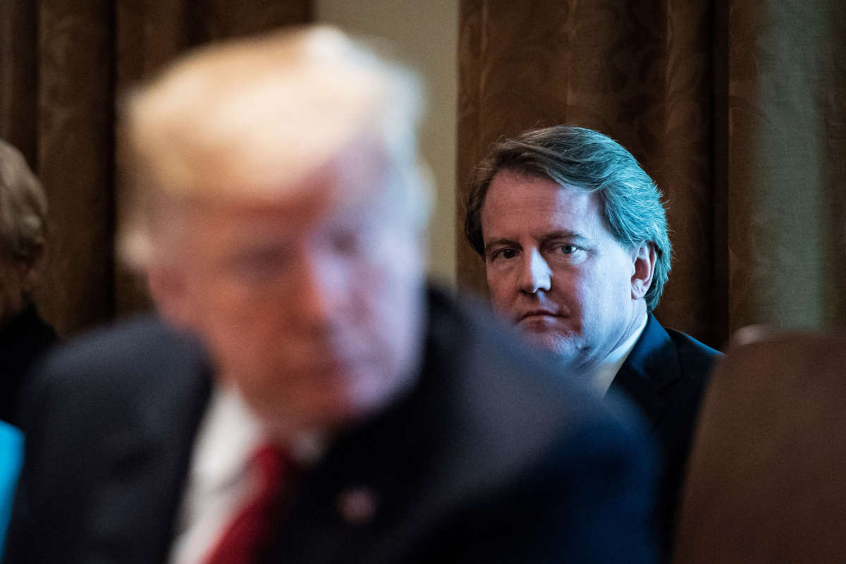 White House Counsel Don McGahn listens behind President Trump during a cabinet meeting in the Cabinet Room of the White House on October 17, 2018, in Washington, D.C.