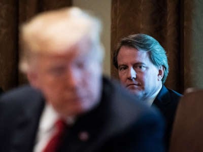 White House Counsel Don McGahn listens behind President Trump during a cabinet meeting in the Cabinet Room of the White House on October 17, 2018, in Washington, D.C.
