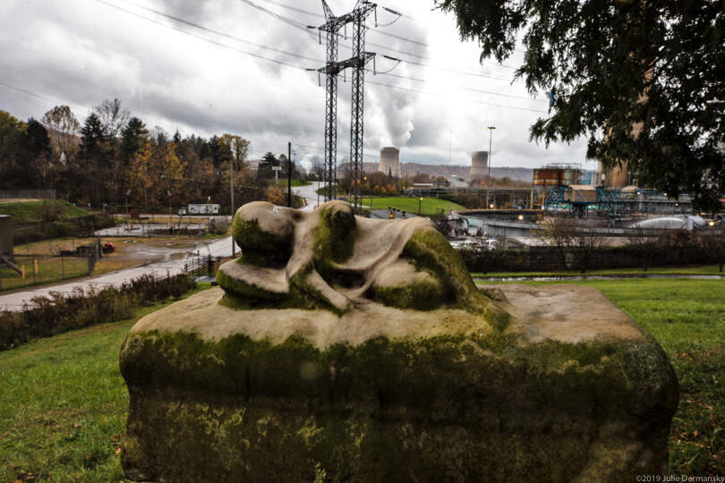 Resting angel on a tombstone in Bethlehem Cemetery in Shippingport, Pennsylvania, next to the Bruce Mansfield coal power plant. Steam in the background rising from the Beaver Valley Nuclear Power Station.