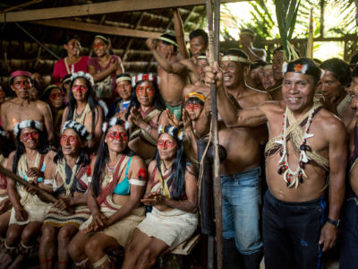 Waorani men and women participate in an assembly in ancestral Waorani territory, Pastaza, Ecuadorian Amazon.