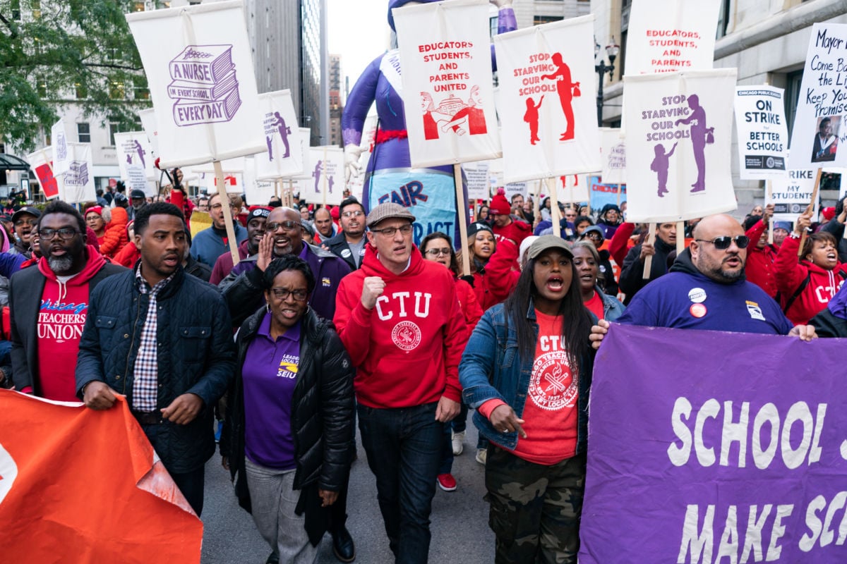 Service Employees International Union (SEIU) President Dian Palmer marches with Chicago Teachers Union President Jesse Sharkey and Vice President Stacy Davis Gates in downtown Chicago on October 14, 2019.