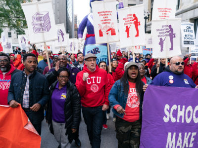 Service Employees International Union (SEIU) President Dian Palmer marches with Chicago Teachers Union President Jesse Sharkey and Vice President Stacy Davis Gates in downtown Chicago on October 14, 2019.