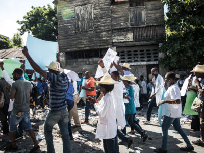 Protesters, medical professionals, and political opponents demonstrate during a demonstration demanding the resignation of President Jovenel Moise in the Haitian capital in Port-au-Prince on October 30, 2019.