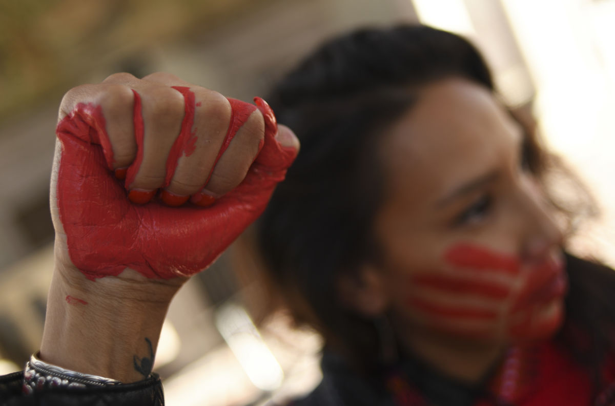 Micaela Iron Shell has painted red hands over their mouth to show solidarity for missing and murdered Indigenous, Black and migrant women and children during a rally with Climate activist Greta Thunberg at Civic Center Park on October 11, 2019, in Denver, Colorado.