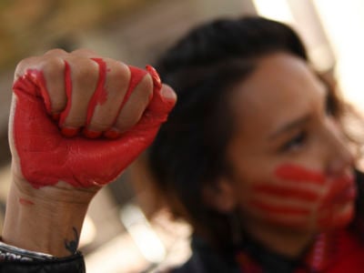 Micaela Iron Shell has painted red hands over their mouth to show solidarity for missing and murdered Indigenous, Black and migrant women and children during a rally with Climate activist Greta Thunberg at Civic Center Park on October 11, 2019, in Denver, Colorado.