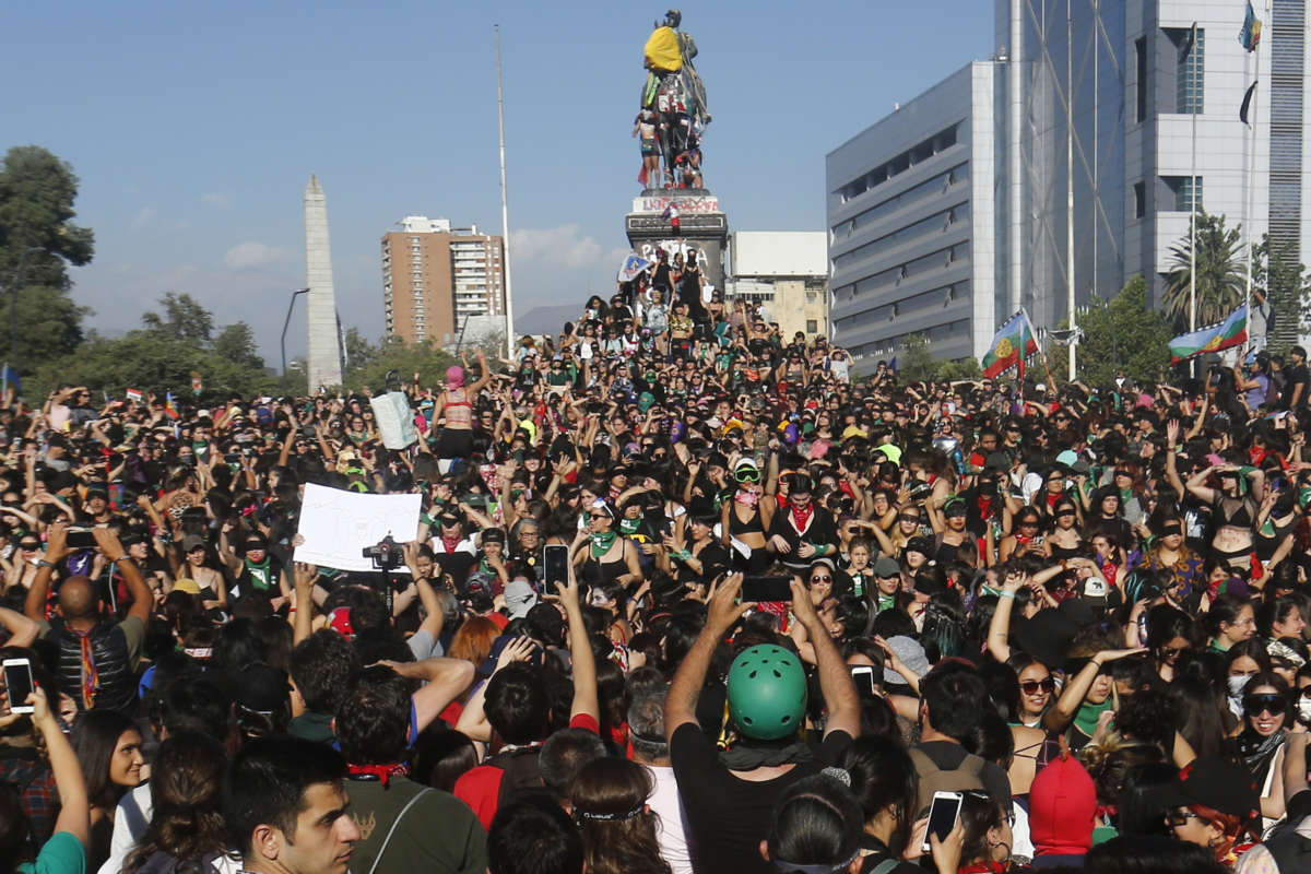 Women shout and perform during the demonstration 'Un violador en tu camino' organized by feminist group Lastesis on November 29, 2019, in Santiago, Chile.