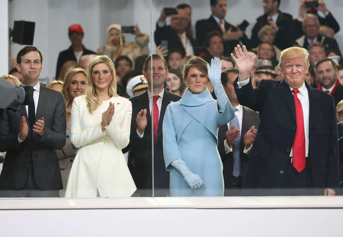 Donald Trump stands with his wife Melania Trump, daughter Ivanka Trump and her husband Jared Kushner, inside of the inaugural parade reviewing stand in front of the White House on January 20, 2017, in Washington, D.C.