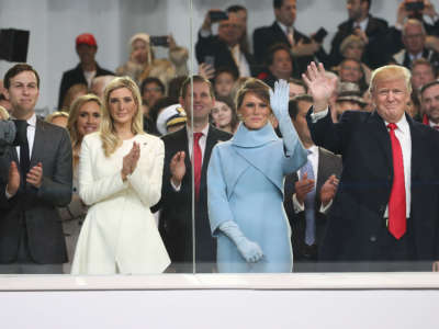 Donald Trump stands with his wife Melania Trump, daughter Ivanka Trump and her husband Jared Kushner, inside of the inaugural parade reviewing stand in front of the White House on January 20, 2017, in Washington, D.C.