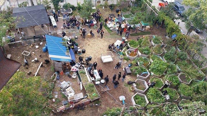 Community gathers near vegetable beds at Bushwick City Farm in 2015.