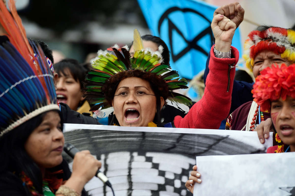 Indigenous people from Brazil take part in a demonstration demanding climate justice outside the venue of the UN Climate Change Conference COP25 in Madrid, on December 9, 2019.