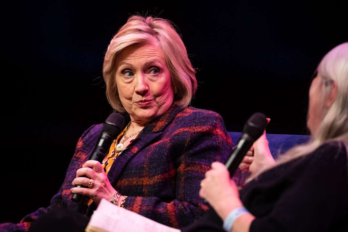 Hillary Clinton makes a face while holding a microphone