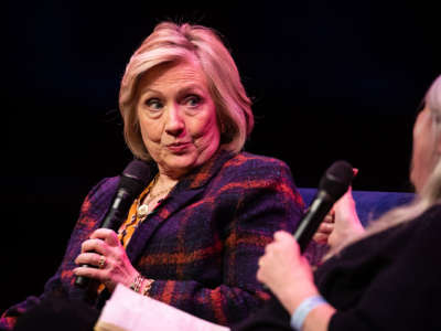 Hillary Clinton makes a face while holding a microphone