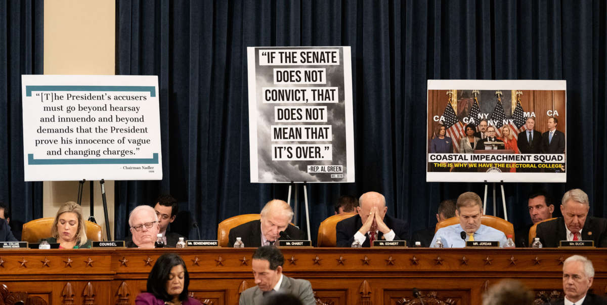 House republicans sit in front of sensationalistic signage