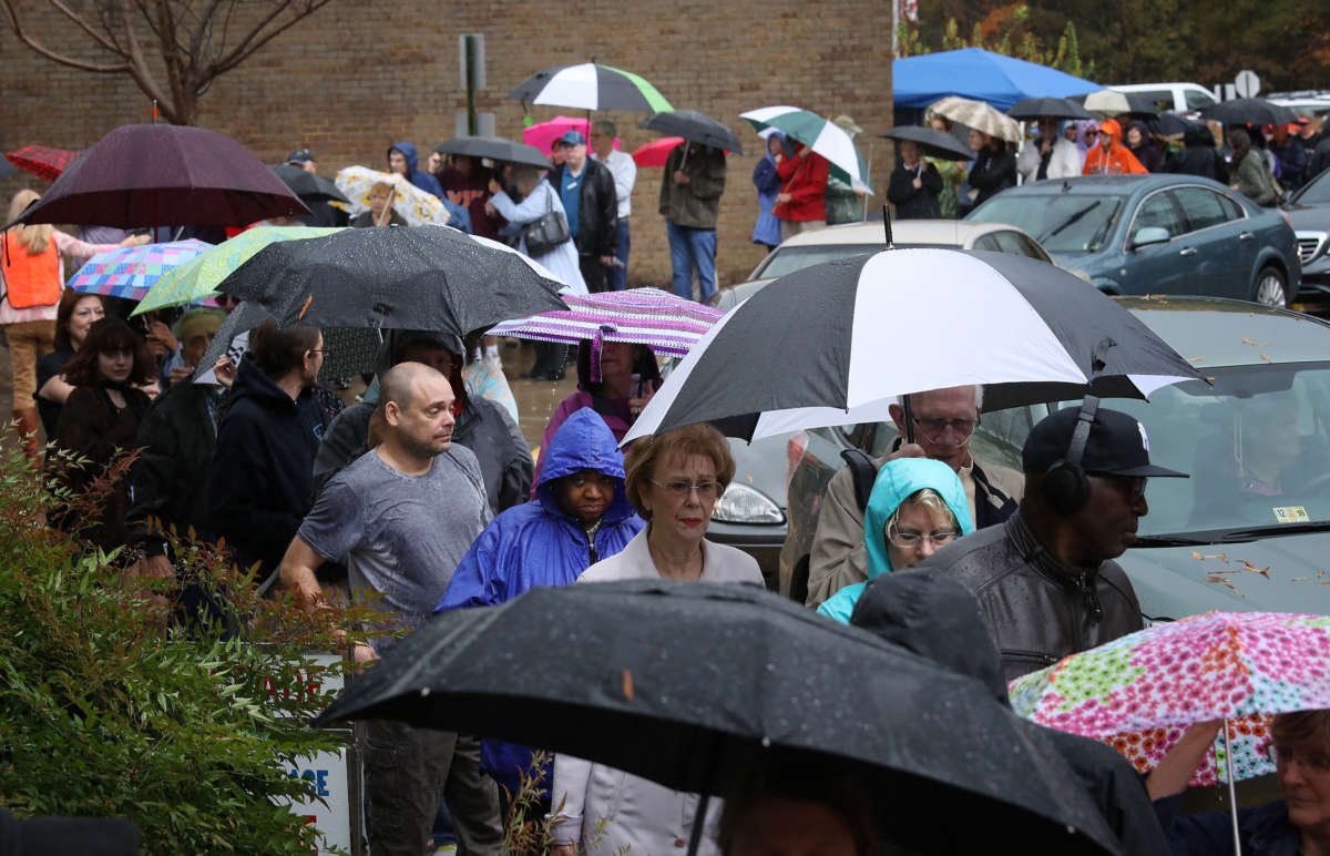 Virginia residents line up to vote in the pouring rain at Robious Middle School, November 6, 2018, in Midlothian, Virginia.