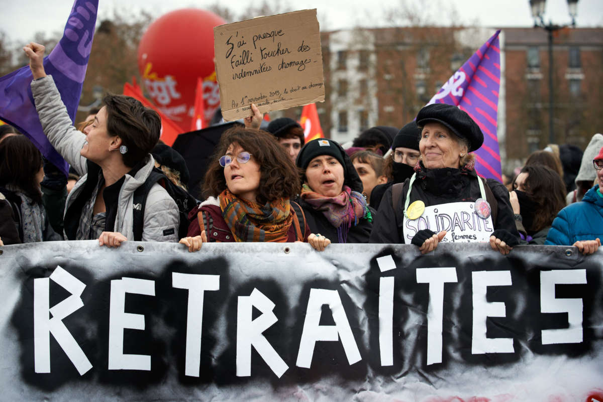 Strikers display a sign reading "RETIRED" in France