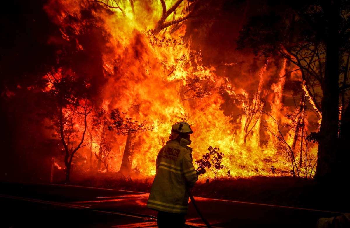 Fire and Rescue personal fight a bushfire as it burns near homes on the outskirts of the town of Bilpin on December 19, 2019, in Sydney, Australia.