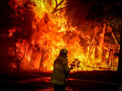 Fire and Rescue personal fight a bushfire as it burns near homes on the outskirts of the town of Bilpin on December 19, 2019, in Sydney, Australia.