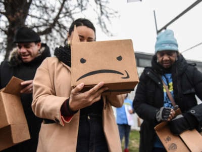 Immigrant and labor activists participate in a rally outside of an Amazon distribution center on December 16, 2019 in the Queens borough of New York City.