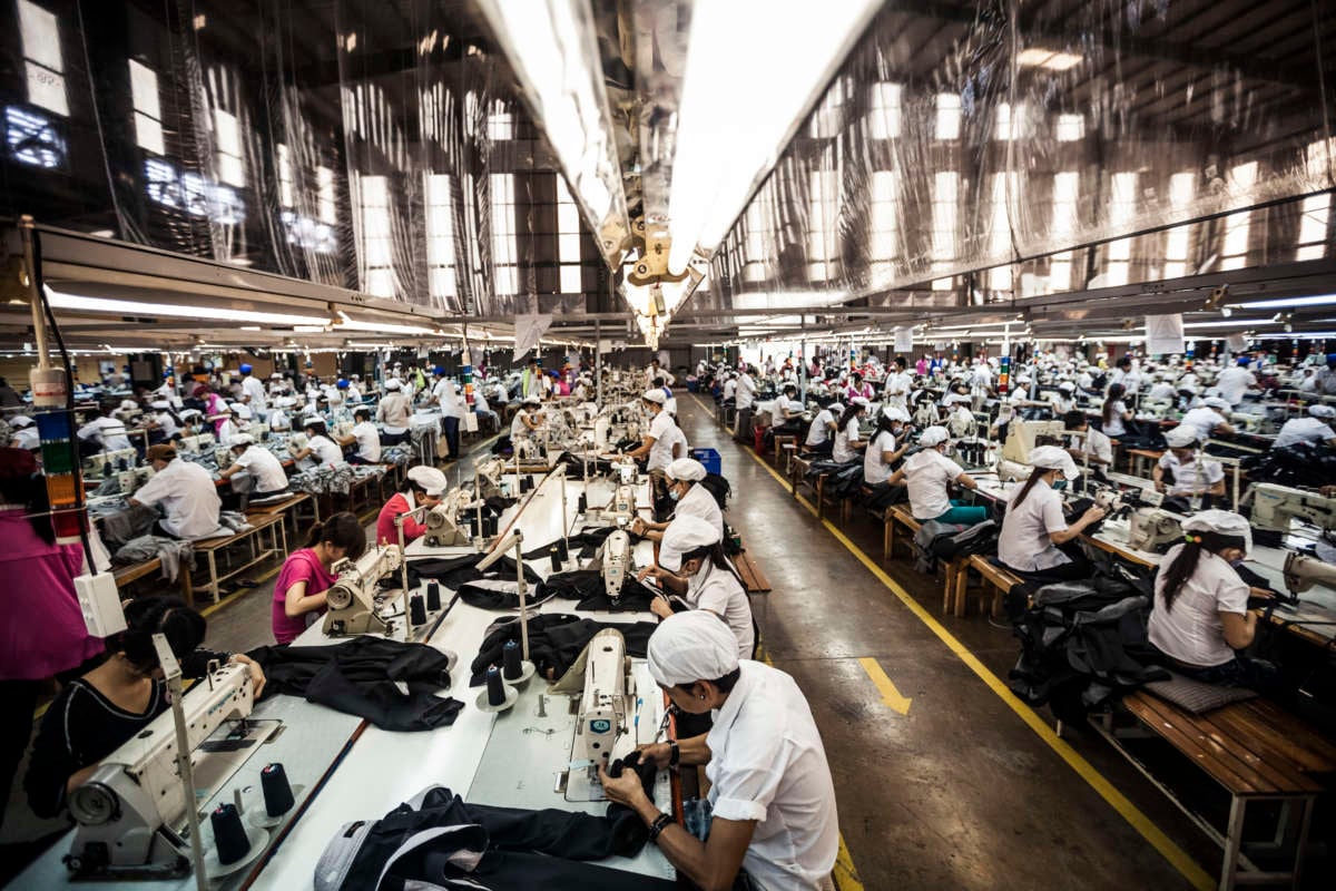 Garment factory workers sewing.