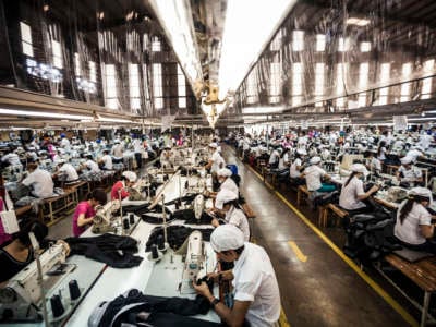 Garment factory workers sewing.