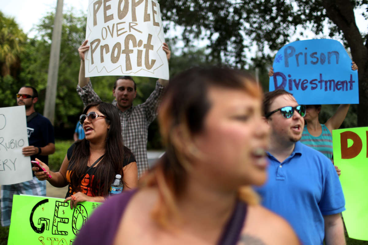 Protesters gather in front of the GEO Group headquarters to speak out against the company that manages private prisons across the United States on May 4, 2015, in Boca Raton, Florida.