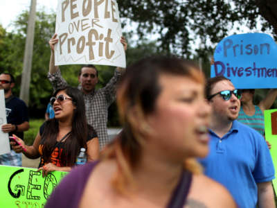 Protesters gather in front of the GEO Group headquarters to speak out against the company that manages private prisons across the United States on May 4, 2015, in Boca Raton, Florida.