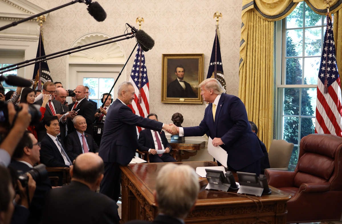 President Donald Trump shakes hands with Chinese Vice Premier Liu He after announcing a "phase one" trade agreement with China in the Oval Office at the White House October 11, 2019, in Washington, D.C.