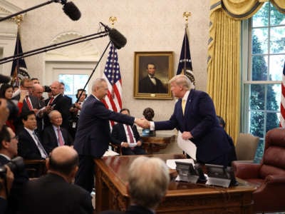 President Donald Trump shakes hands with Chinese Vice Premier Liu He after announcing a "phase one" trade agreement with China in the Oval Office at the White House October 11, 2019, in Washington, D.C.