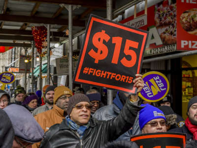 Workers in the "Fight for $15" demonstrate during the lunchtime rush to demand the rejection of fast-food mogul, Andy Puzder, as labor secretary in New York City on February 13, 2017.