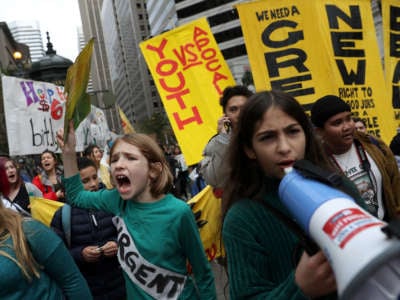 Protesters march along Market Street during a youth climate strike on December 6, 2019, in San Francisco, California.