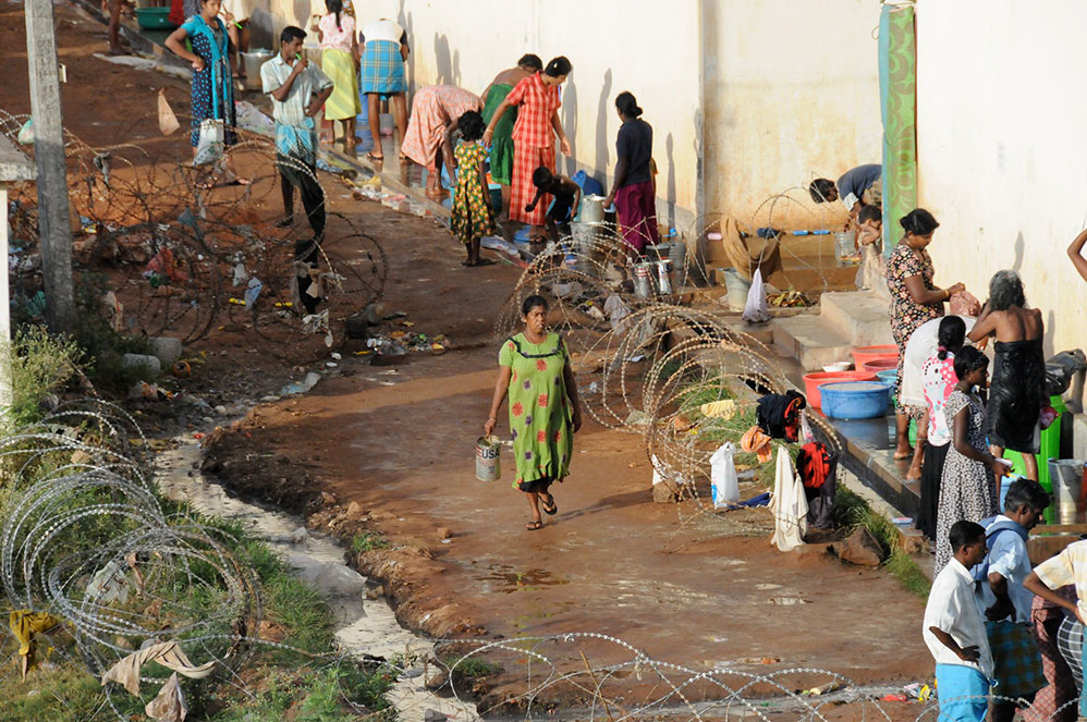 People line up to receive water at a camp for internally displaced people in Vavuniya, Sri Lanka, in 2009.