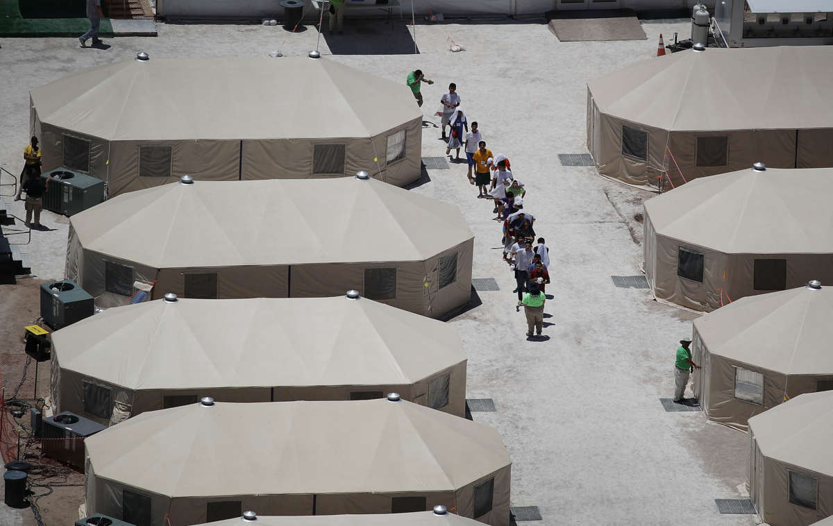 Children and workers are seen at a tent encampment built near the Tornillo Port of Entry on June 19, 2018, in Tornillo, Texas.