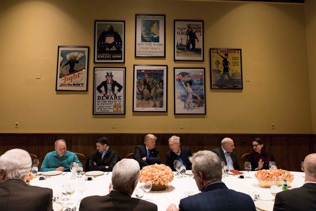 President Trump listens to Senate Majority Leader Mitch McConnell during a dinner with legislative leadership at Camp David, on January 5, 2018.