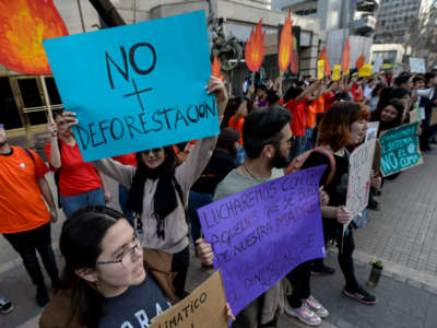 People hold signs during a protest