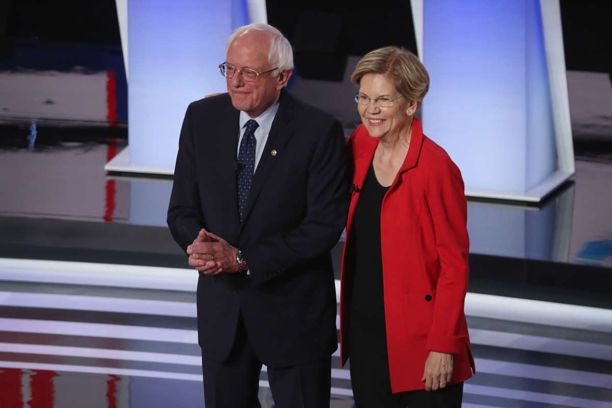 Democratic presidential candidates Sen. Bernie Sanders and Sen. Elizabeth Warren take the stage at the beginning of the Democratic Presidential Debate at the Fox Theatre July 30, 2019 in Detroit, Michigan.