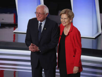 Democratic presidential candidates Sen. Bernie Sanders and Sen. Elizabeth Warren take the stage at the beginning of the Democratic Presidential Debate at the Fox Theatre July 30, 2019 in Detroit, Michigan.