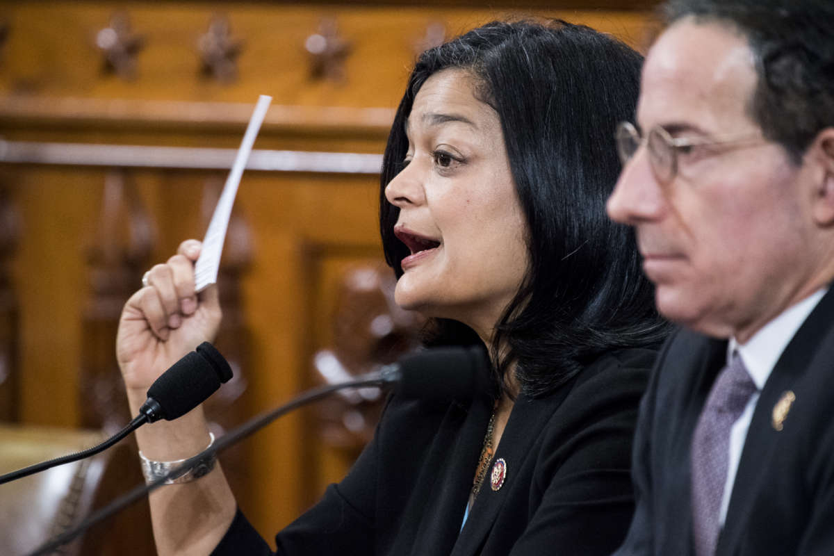 Rep. Pramila Jayapal holds up a pocket Constitution as she votes yes in the House Judiciary Committee markup of the articles of impeachment against President Donald Trump on Friday, December 13, 2019.
