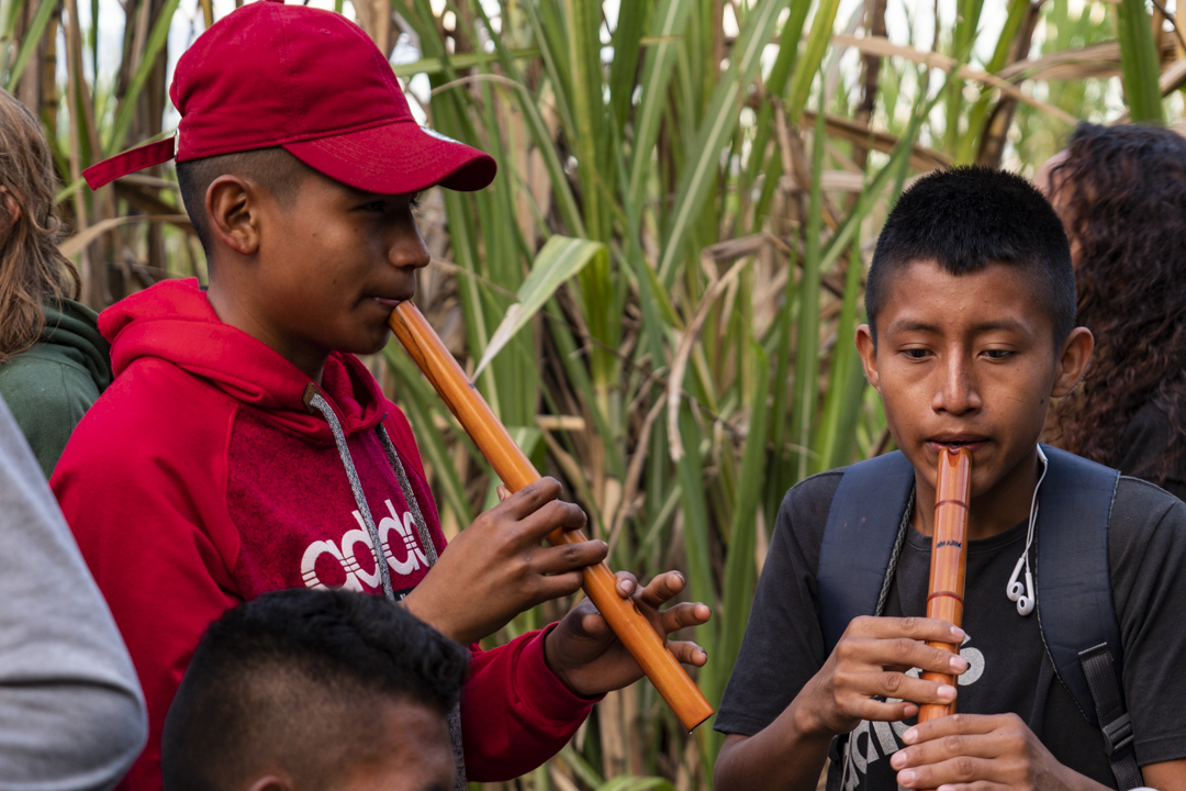 Two boys play pipes