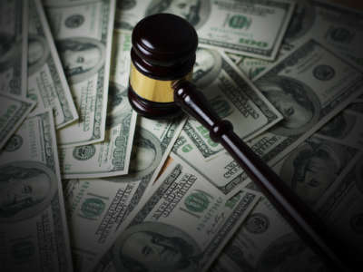 A gavel sits on top of money