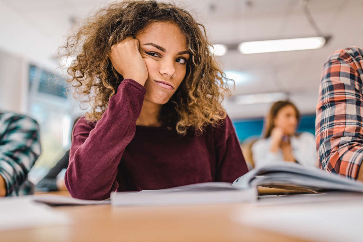 A student looks on at a teacher in irritation