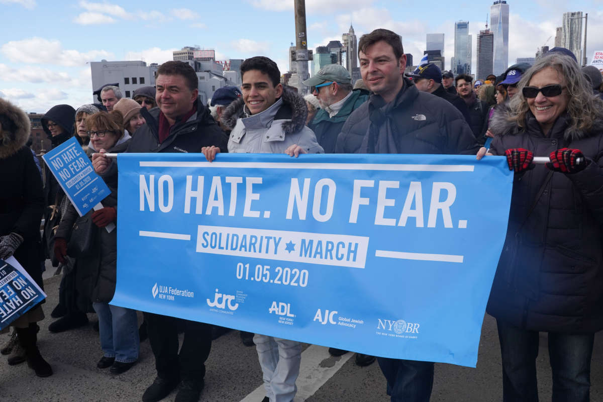 Activists carry a sign reading "NO HATE. NO FEAR" during a protest