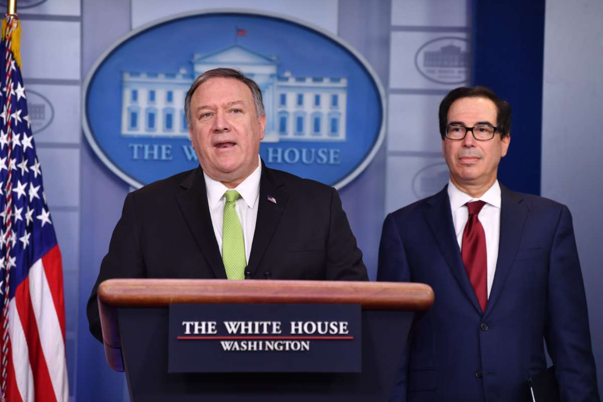 Mike Pompeo stands at a podium next to Steve Mnuchin