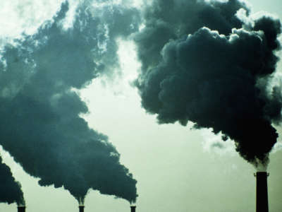 Smoke billows into the air from smokestacks